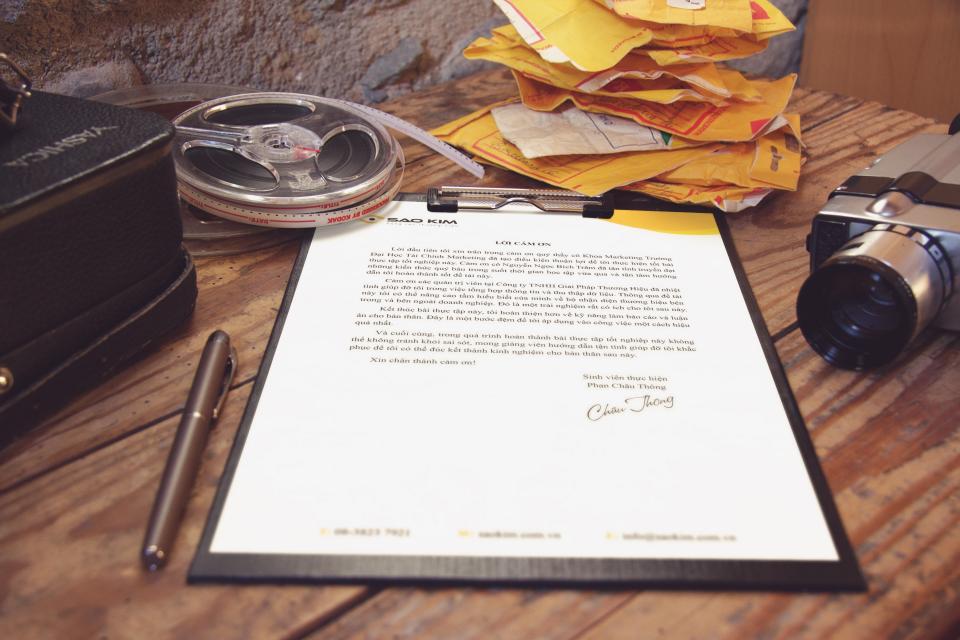 Paperwork on a clipboard on a wooden desk